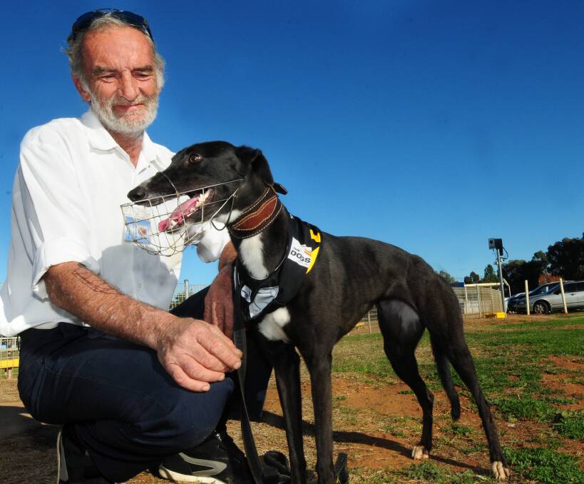 Happier times: Warren Jarvis with one of his greyhounds after a win at Dubbo in 2014. Photo: FILE