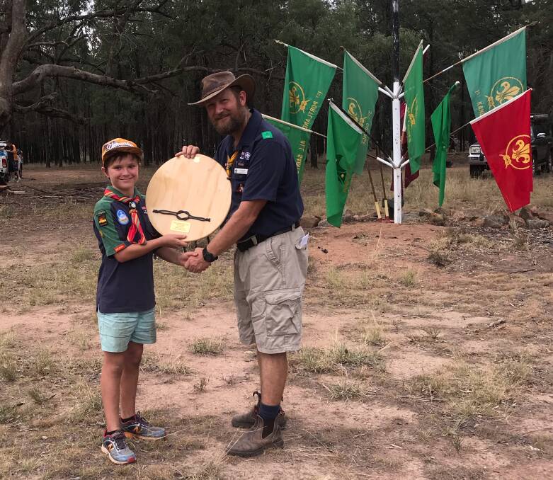 Scout's honour: Joel Taylor from Dubbo receives his award from Scouts region commissioner Gavin Arnold at the Golden West Bunyip camp. Photo contributed.