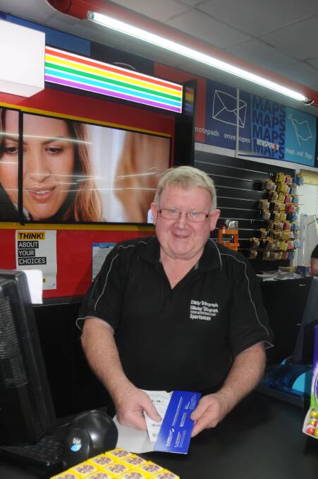 Talbragar Street Newsagency owner Peter Snare checking Lotto tickets for the winning numbers. Photo: FAYE WHEELER