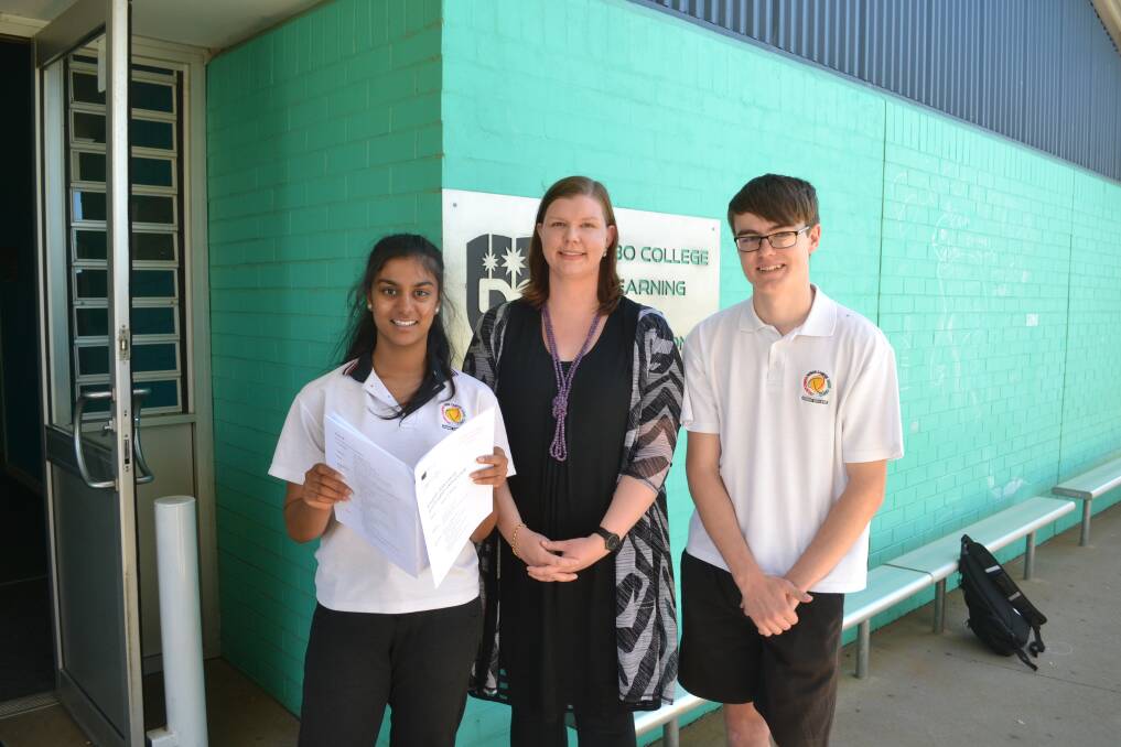 Positive reaction: Dubbo College Year 12 students Ashwini Manorathan and Ethan Hughes (right) with English teacher Marie Speer meet up after the first HSC exam. Photo: FAYE WHEELER