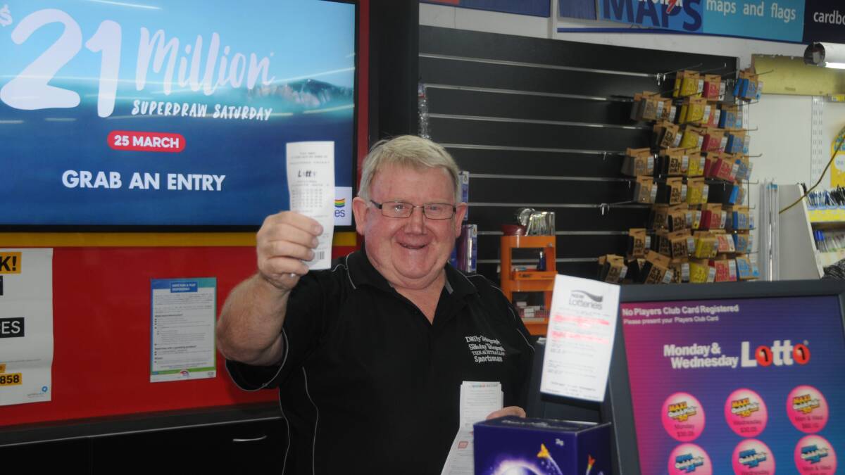 Mystery millionaire: Talbragar Street Newsagency's Peter Snare checks for the lucky numbers after the store sold a winning Lotto ticket. Photo: FAYE WHEELER.