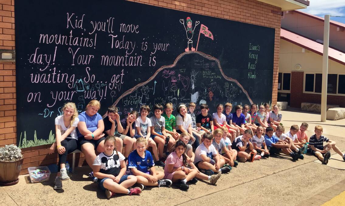 Mighty support: Year 5 students at St Laurence's Primary School encourage Isaac Minney (back row, ninth from left) ahead of his Krazy Kosci Klimb. Photo: FAYE WHEELER