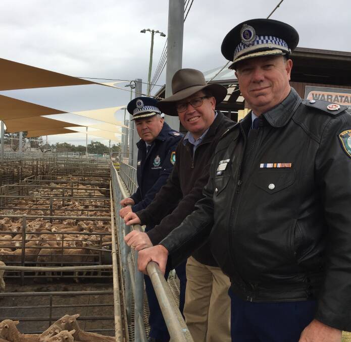 NSW Deputy Commissioner for regional field operations Gary Worboys, NSW police minister Troy Grant and western region commander Assistant Commissioner Geoff McKechnie at the Dubbo Regional Livestock Markets. Photo: FAYE WHEELER