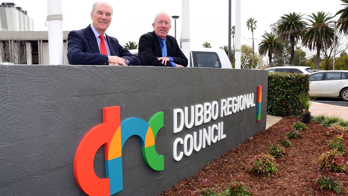 Dubbo Regional Council acting interim general manager David Dwyer and administrator Michael Kneipp with the recently-unveiled logo earlier this month. The council has now adopted an interim integrated organisational structure as it continues work on merging the former Dubbo City and Wellington councils. Photo: BELINDA SOOLE 