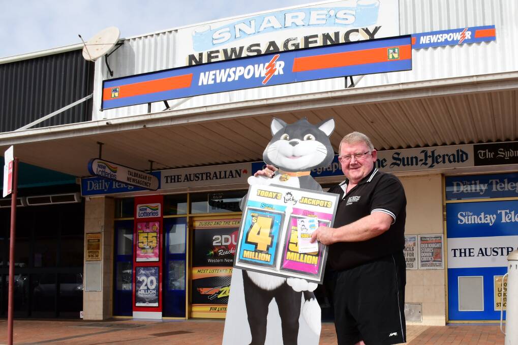 All smiles: Talbragar Street Newsagency owner Peter Snare with Lucky Lotteries mascot Lucky the Cat waiting to unite a customer with their prize of more than $4.9 million. Photo: AMY MCINTYRE