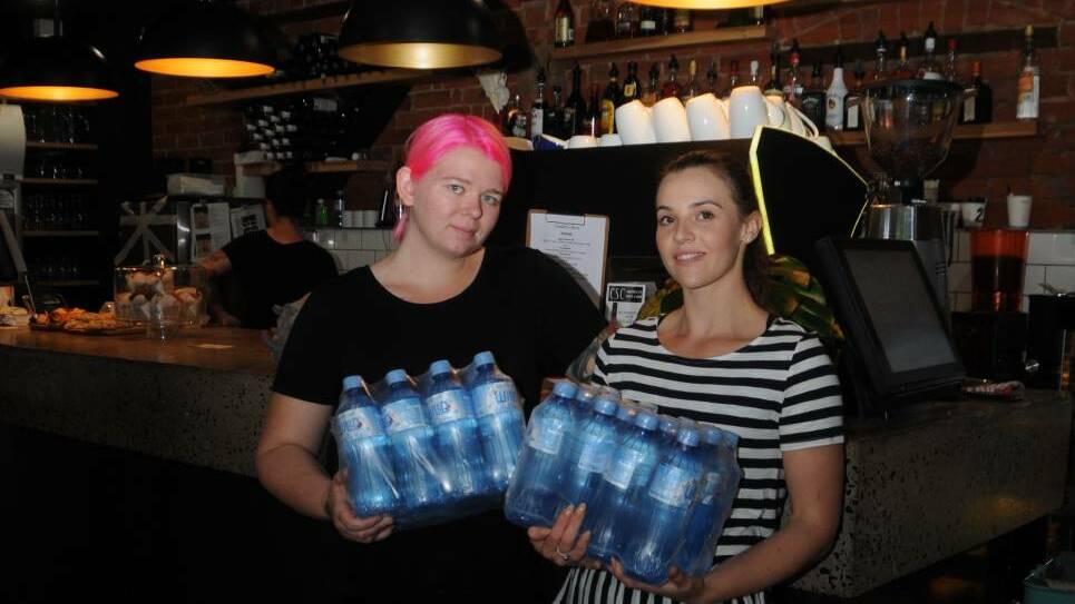 Errin Williamson and Ashleigh Wyatt at CSC, where they are providing customers with free bottled water. Photo: JENNIFER HOAR