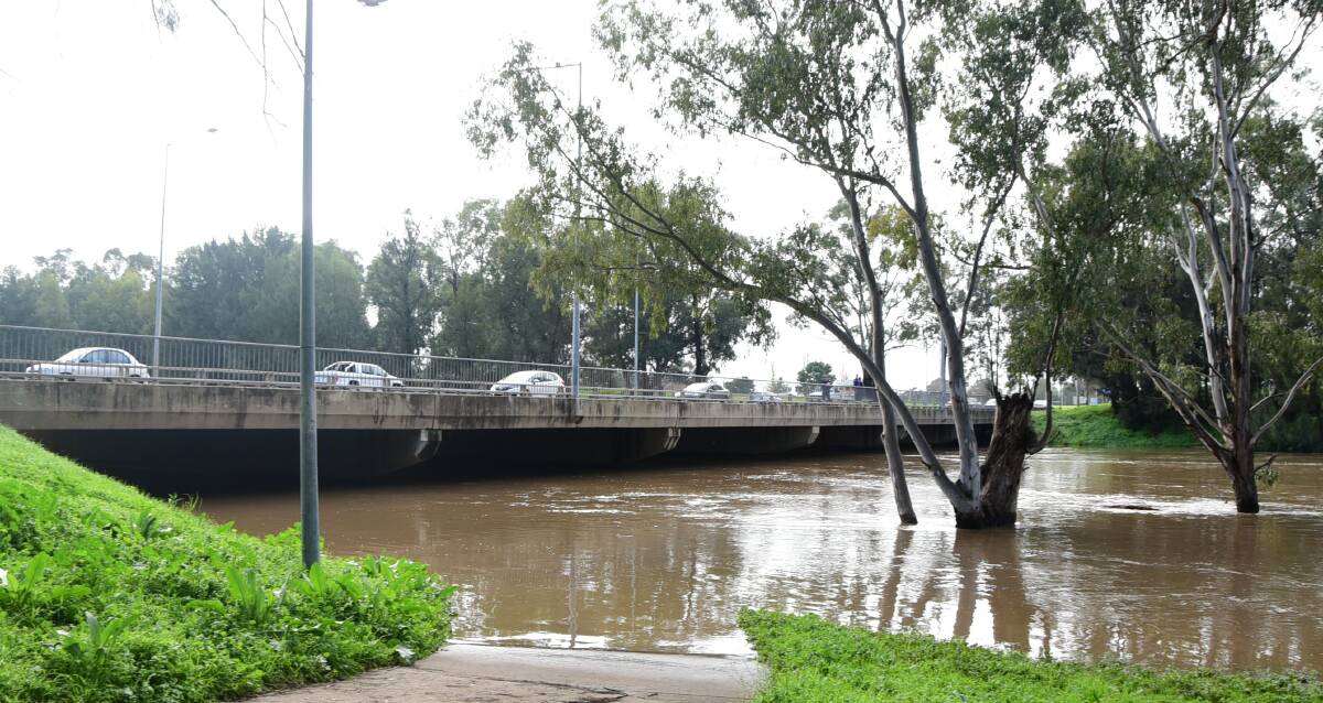 Threat avioded: At its peak, the Macquarie River lapped at the underside of the Emile Serisier Bridge. Now the clean-up begins. Photo: BELINDA SOOLE
