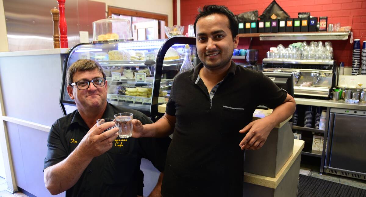 Tim Houghton and Santosh Gc are glad to have tap water back on the menu at Grapevine Cafe. Photo: JENNIFER HOAR