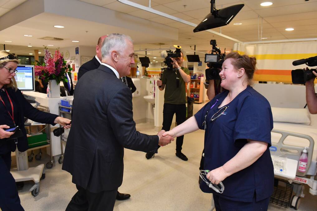 MILESTONE: Prime Minister Malcolm Turnbull meets with a nurse on a cancer ward at Sydney's Royal North Shore Hospital. Photo: MICK TSIKAS/ AAP IMAGE