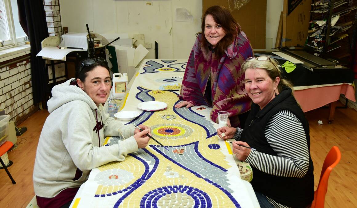 Piece by piece: Emah Tolmie, Brigid Palin and Jenny Slack-Smith create their mosaic mural. Photo: BELINDA SOOLE