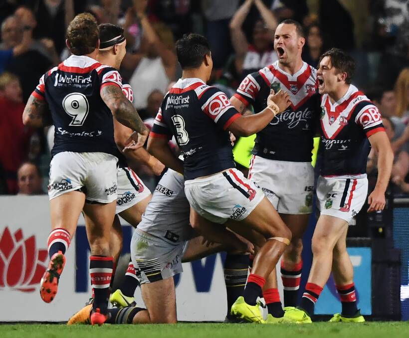 Connor Watson (right) and his Roosters teammates celebrate after his try against the North Queensland Cowboys at the Allianz Stadium in Sydney. Photo: DAVID MOIR/ AAP IMAGE