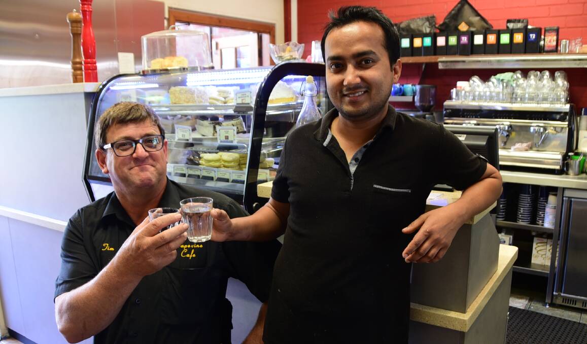 Back on tap: Tim Houghton and Santosh Gc were glad to have tap water back on the menu at Grapevine Cafe. Photo: JENNIFER HOAR
