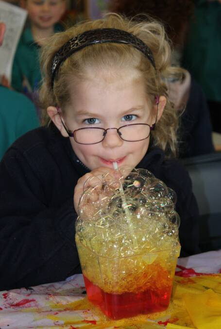 Bubbly fun: Emma experiments at the school's Science Day. Photo: Supplied.
