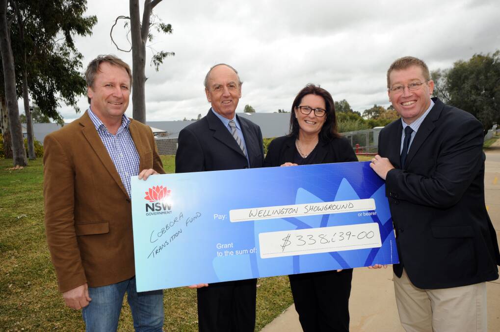 Wellington Showground Society treasurer Alan Hutchinson and president Danielle Anderson are presented their funding by Barwon MP Kevin Humphries (left) and Dubbo MP Troy Grant (right). Photo: BELINDA SOOLE