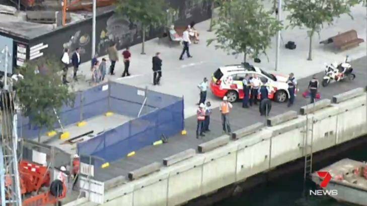 Police and emergency services attend the scene of a workplace accident on a barge at Barangaroo. Photo: Seven News