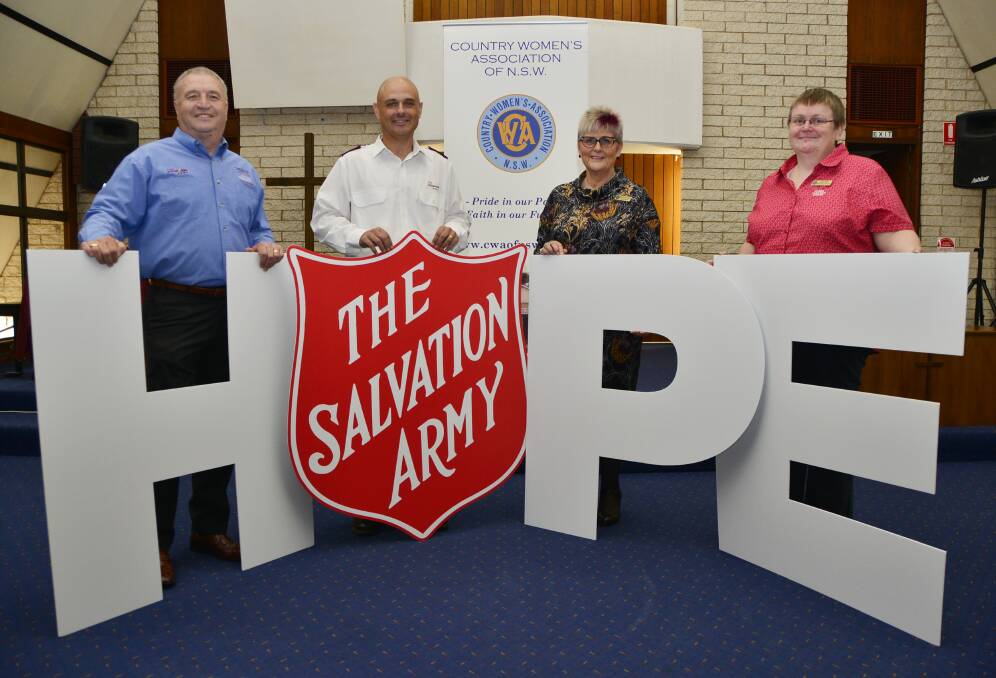 The Salvation Army s Gerard Byrne and Mark Townsend with Tanya Cameron and Ruth Cargill from the Country Women s Association.                                                                                            Photo: BELINDA SOOLE