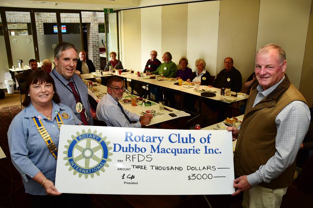 Dubbo Rotary Macquarie President Lorraine Croft and book fair co-ordinator Peter Bartley presents the cheque to Dubbo RFDS Support Group President Terry Clark.                                   Photo: BELINDA SOOLE