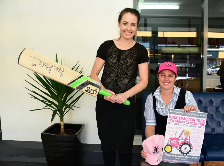 Kate Slade and Shayna Chapman display the cricket memorabilia, signed by Glenn McGrath and Brad Haddin, that will go up for auction as the Real Estate Institute of NSW - Orana division supports Hugh Bateman's Pink Tractor Trek to raise money for breast cancer care.  
Photo: BELINDA SOOLE