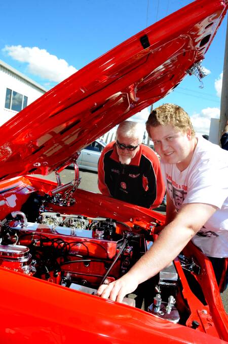 ABOVE: Cailey Lack, 7, and Mattea Lack, 4, had a wonderful day at the bike and car show. RIGHT: Cory Rosser and his father Garry Rosser check out the engine of Cory's LX Torana. 
Photo LOUISE DONGES