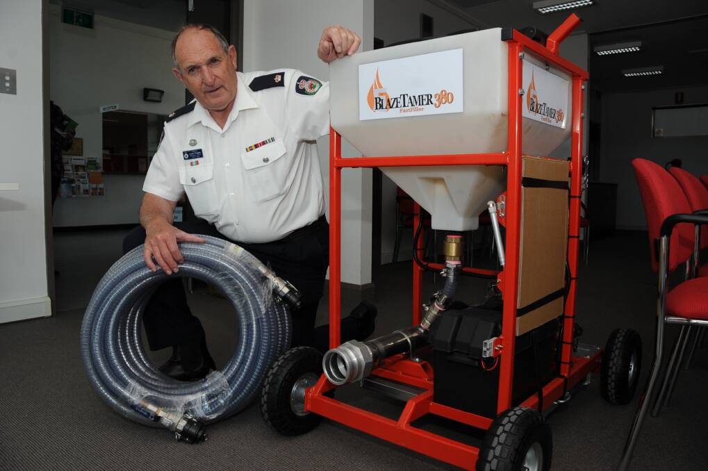 Orana RFS Operations Officer Laurie Douglas shows off a new piece of equipment to help with aerial firefighting operations.   		      Photo: BELINDA SOOLE.