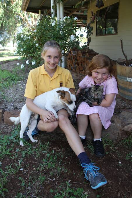 Dugald Saunders' daughters Georgie and Charlie with pets DJ and an unimpressed Tessa.