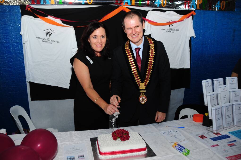 Dubbo Neighbourhood Centre manager Debbie Todkill and mayor Mathew Dickerson cut the 40th birthday cake.  Photo: BELINDA SOOLE