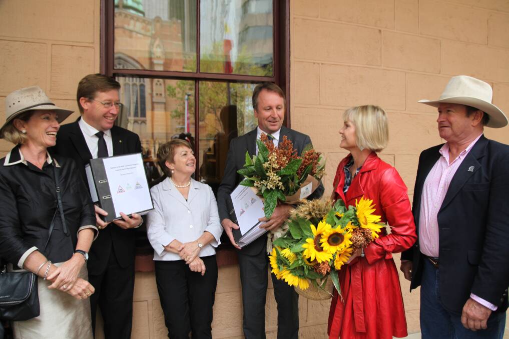 North west NSW residents Nicky Chirlian, Anne Kennedy, Penny Blatchford and David Quince present Member for Dubbo Troy Grant and Member for Barwon Kevin Humphries with a 10,000 signature petition for protection from coal seam gas mining.  
	Photo: KATE AUSBURN