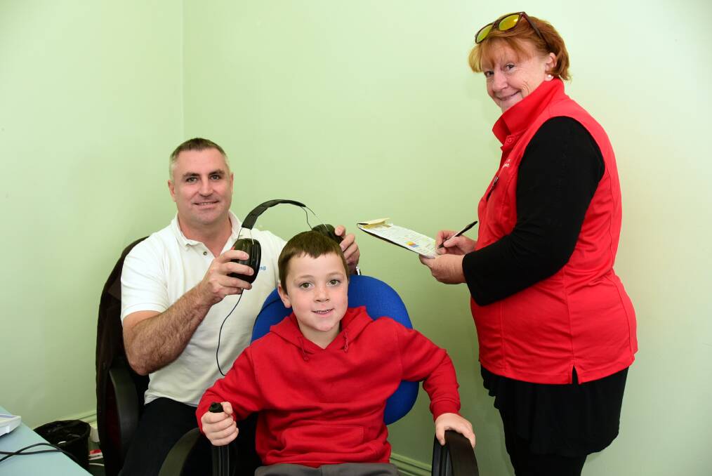 Gordon Rutter, Central Coast Hearing audiologist, Dubbo Public School year 1 student Connor Farrawell and Hear Our Heart ear health manager Kerry Inder.  
 
			        Photo: BELINDA SOOLE
