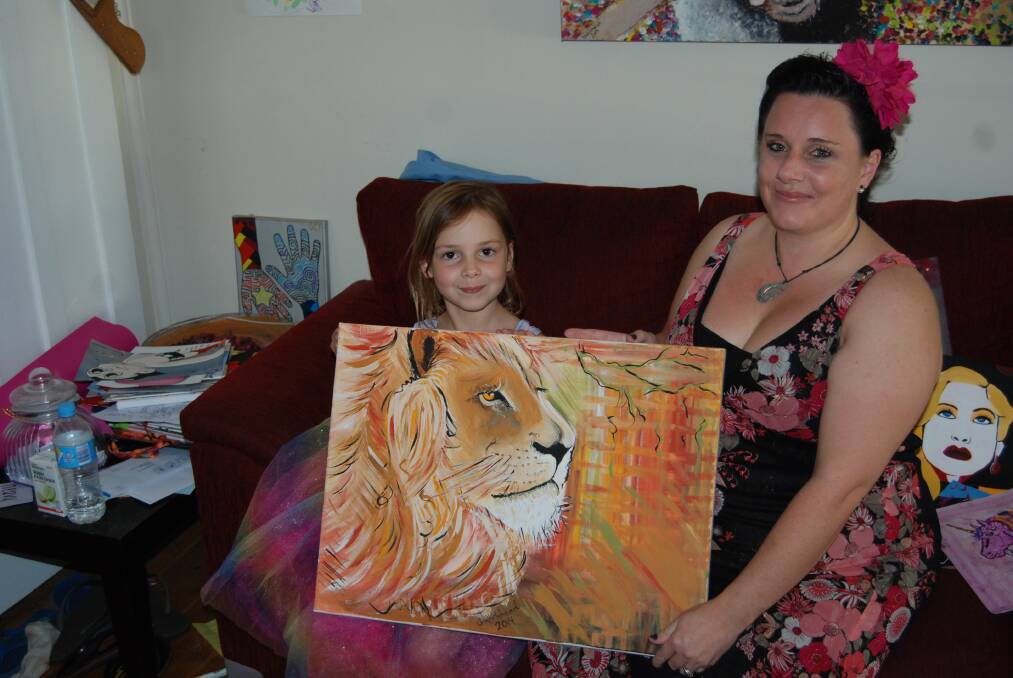 Sacha Whitehead and her daughter Halli with some of the artworks Sacha has painted to raise money for Parkinson's Disease research. Photo: GRACE RYAN