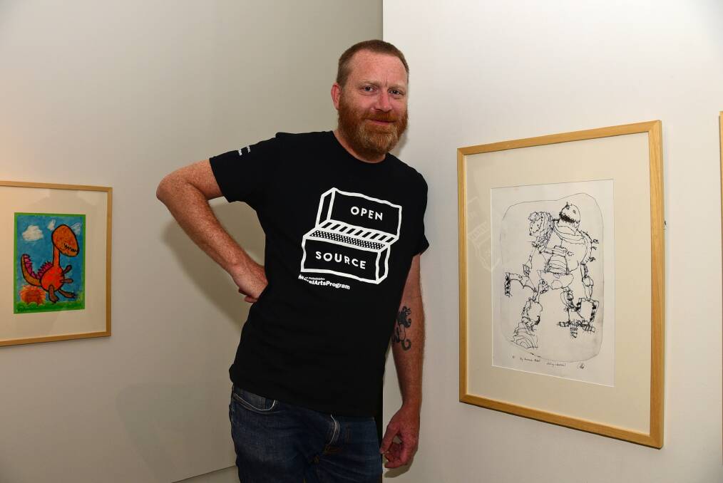 Western Plains Cultural Centre curator Kent Buchanan is drawn to an etching of a robot that features in Operation Art. Photo: BROOK KELLEHEAR-SMITH