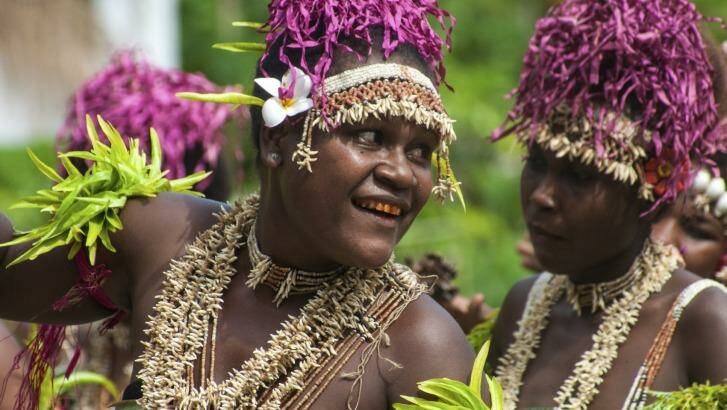 Villagers on Santa Ana Island perform  welcome dances for guests. Many have teeth dyed red through years of chewing betel nuts.
 Photo: iStock