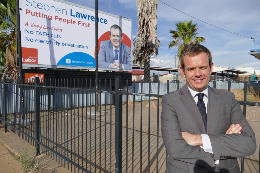 Labor candidate for the seat of Dubbo Stephen Lawrence unveils a billboard in the city's centre as part of his campaign to enter NSW Parliament.
