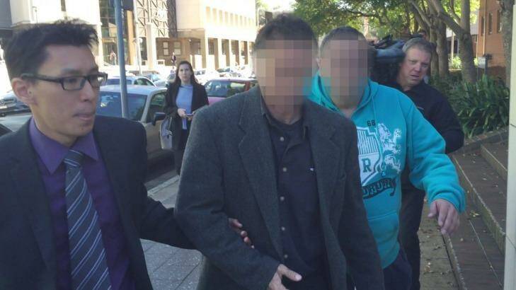 The boy's father, in the middle, leaves Parramatta Children's Court on Wednesday with lawyer Tang. Photo: Supplied
