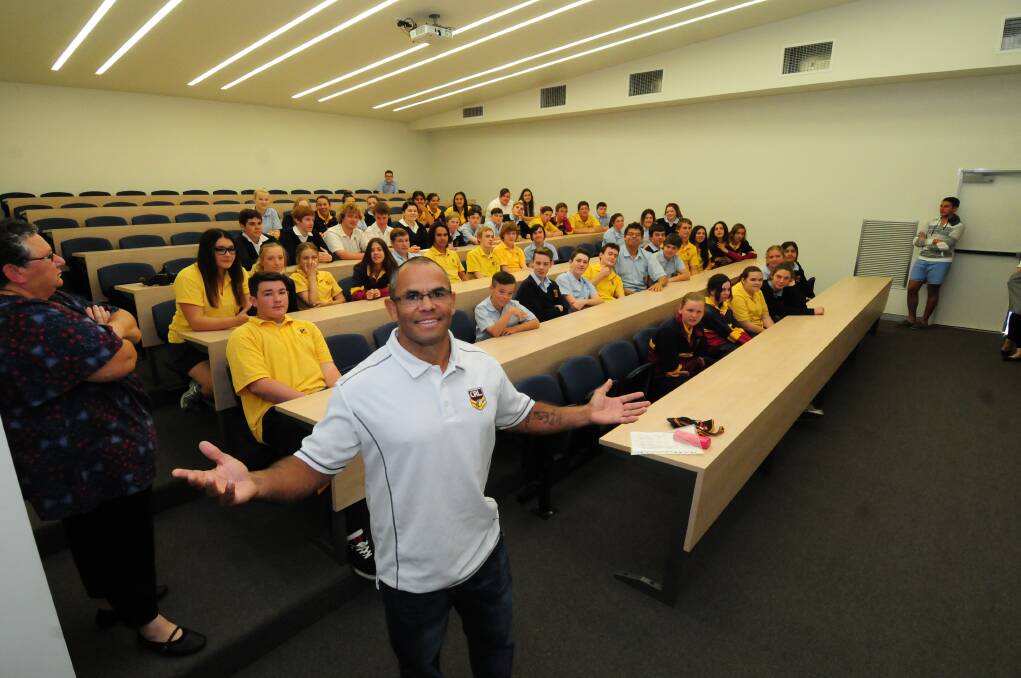 Former Parramatta star Dennis Moran with students of St John's College at yesterday's workshop. 			      Photo: GREG KEEN