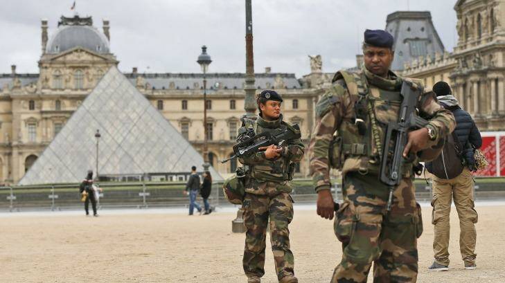 Soldiers patrol in the courtyard of the Louvre Museum in Paris, November 17, 2015.  (AP Photo/Frank Augstein)