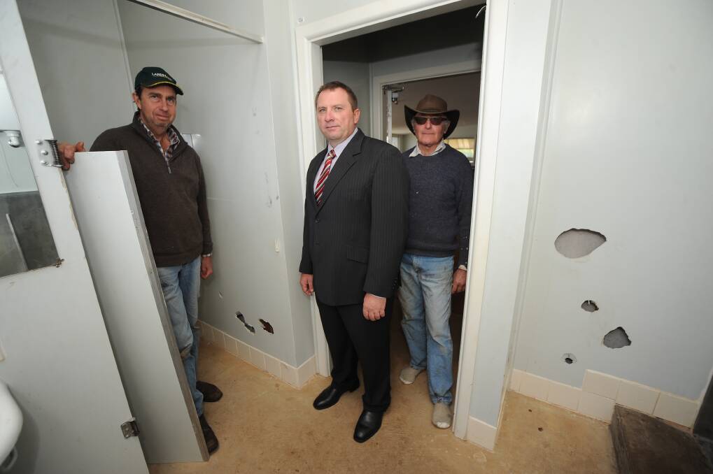 Dubbo City Councillor Greg Mohr (centre) inspects a door ripped off and other damage of the Wongarbon Hall with hall advisory committee members Scott Woodley and John Kelly.  
Photo: BELINDA SOOLE