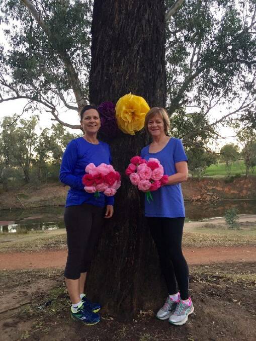Dubbo parkrun run director Karen Pellow and volunteer Deb Aldis with some of the flowers ready for Mother's Day at parkrun. Photo: CONTRIBUTED