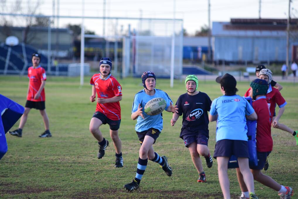 Lachlan Sinclair receives the ball during the Roos under-13s training session.