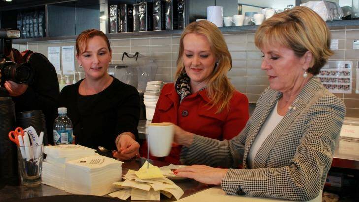 Coffee Club employee Patsy Polchleb, of Jamisontown, helps Foreign Minister Julie Bishop make a cappuccino at Nepean Village shopping centre, Penrith, while Lindsay MP Fiona Scott looks on. Photo: Krystyna Pollard.
