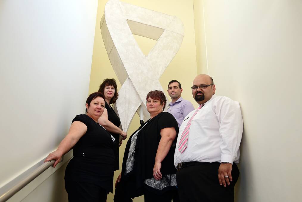 Dubbo Community Corrections staff Lorraine Holland, Narelle Jeffrey, Jodie Patterson, Lyndon Davis and Kevin Jones supporting the White Ribbon campaign. 	Photo: BELINDA SOOLE