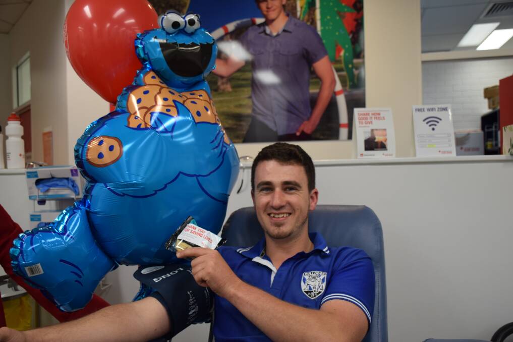 John Fernance gets "Australia's best biscuit" after giving blood at the Dubbo Donor Centre. 							   Photo: Contributed