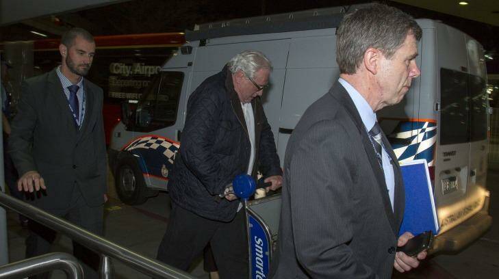 Andrew McManus being escorted by police.  Photo: Luis Ascui