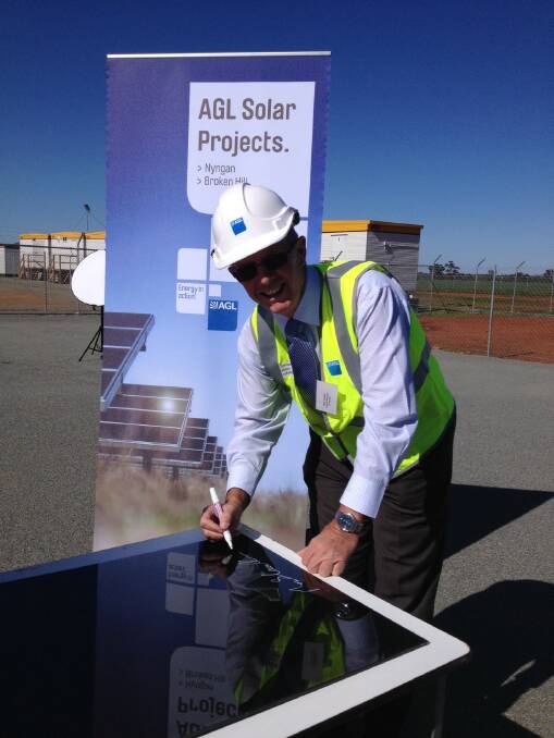 Parkes MP Mark Coulton signs one of the landmark first panels at Nyngan Solar Plant. 
Photos contributed.