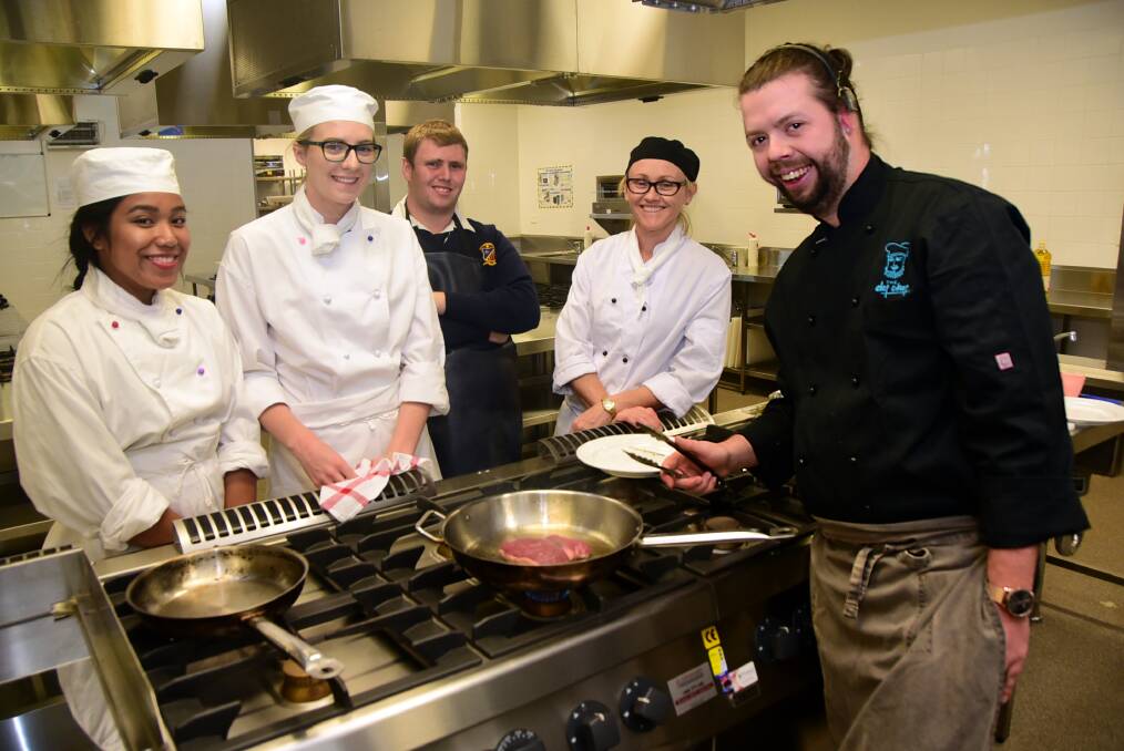 St John's College students Jastine Venua, Samantha Conte and Sam Barnes, alongside teacher Cecilia O'Donnell learnt how to cook a perfect steak from The Def Chef's Andrew Hockey on Wednesday. Photo: BELINDA SOOLE