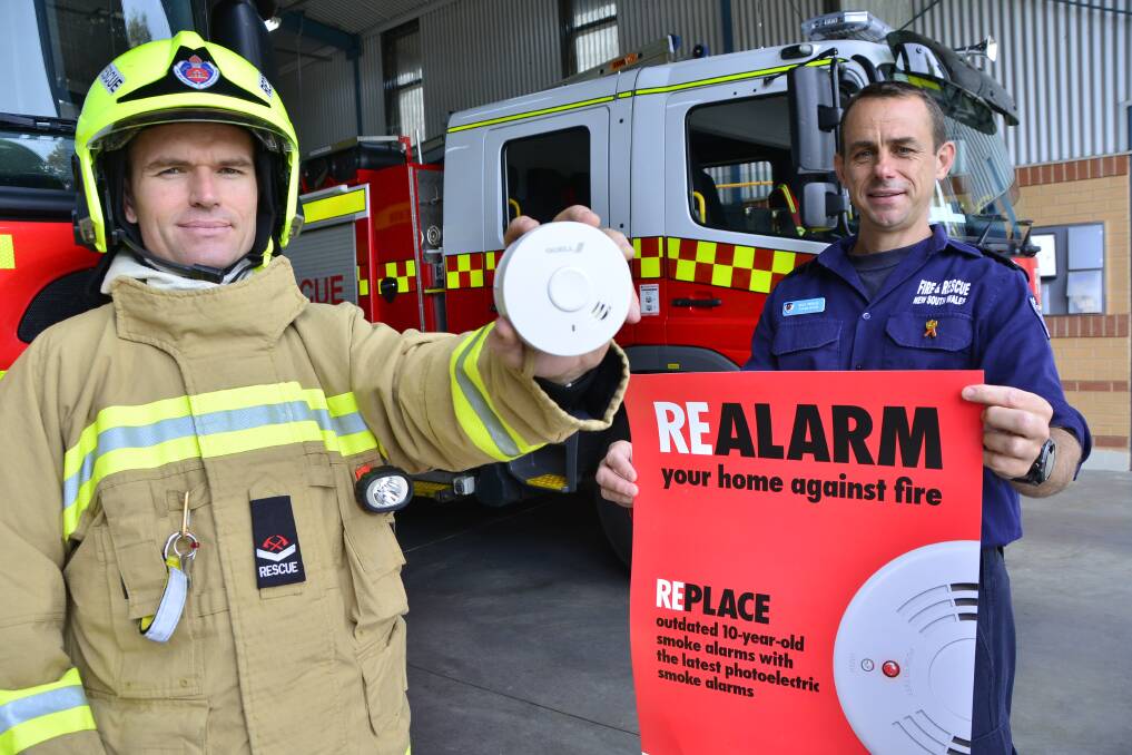 Dubbo Fire and Rescue officers Brad Edwards and Mick Medlin are encouraging the community to change their smoke alarms if they are more than 10 years old. 	Photo: BELINDA SOOLE