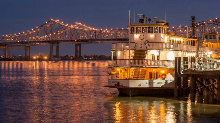 A riverboat on the Mississippi River in New Orleans at dusk.