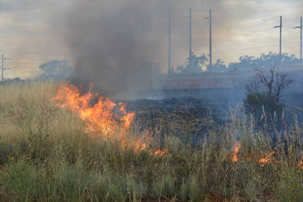 Firefighters were called to the scene of a fire on the Mudgee Road near Wellington on Tuesday that threatened the local Transgrid substation. 	             Photo: FARREN HOTHAM