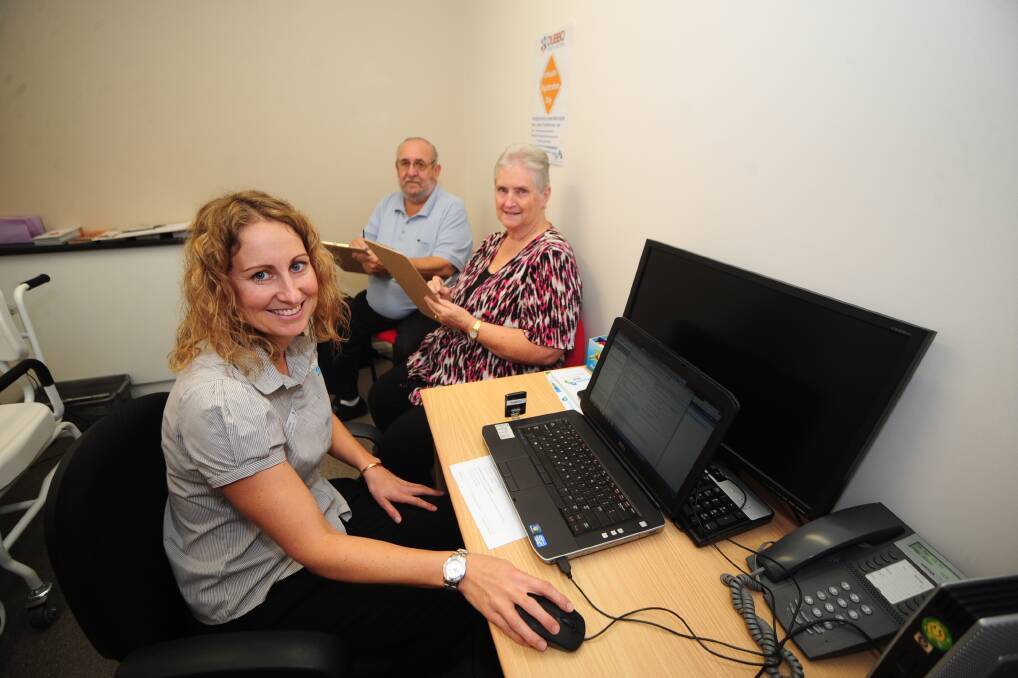 Western NSW Medicare Local eHealth project officer Brooke Winterton helps Geoffrey and Judith Smith register for free eHealth Records. 						   Photo: BELINDA SOOLE