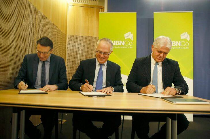 SYDNEY, AUSTRALIA - DECEMBER 14:  Signing agreements for NBN Co L to R Telstra Chief, David Thodey, Minister for communications Malcolm Turnbull, and Bill Morrow chief of the NBN Co today. The Commonwealth Government, NBN Co and Telstra sign landmark agreements to allow the NBN to be completed sooner and at less expense.December 14, 2014 in Sydney, Australia.  (Photo by Michele Mossop/Fairfax Media)