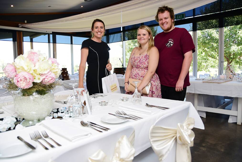 Lazy River Estate function co-ordinator Kelly Reynolds showing Lauren Wesbury and Richie Gilpin potential table settings. 				      Photo: BELINDA SOOLE